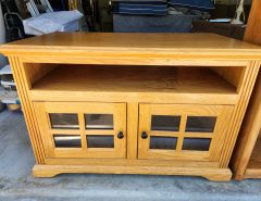 Honey oak TV stand with glass doors. The Villages Florida