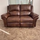 Haverty’s brown leather reclining loveseat (manual). The Villages Florida