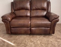 Haverty’s brown leather reclining loveseat (manual). The Villages Florida