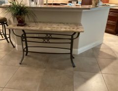 Sofa/console table features a polished fossil stone tiled top paired with an elegant, hand-crafted wrought-iron base $125. The Villages Florida