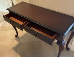 Console/ table, solid wood in a dark color with 2 drawers.   $100. The Villages Florida
