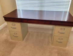 Makeshift Office desk … a nice solid wood desk top sitting on two file cabinets.   $60. The Villages Florida