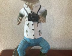 Really cute tourist alligator statue is dressed up for vacation.  He is 1 1/2 feet tall, cast resin $45. price tag on bottom……….Sell for $20. The Villages Florida